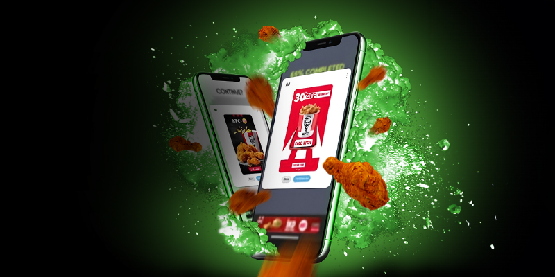Smartphones displaying KFC in-app offers with fried chicken pieces bursting outward against a green digital background, representing mobile food ordering and in-game advertising.